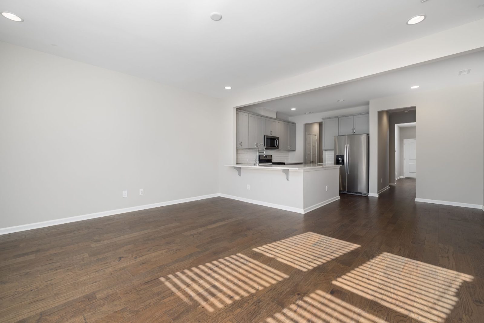 Empty living room with wood floors ready for a move-out clean