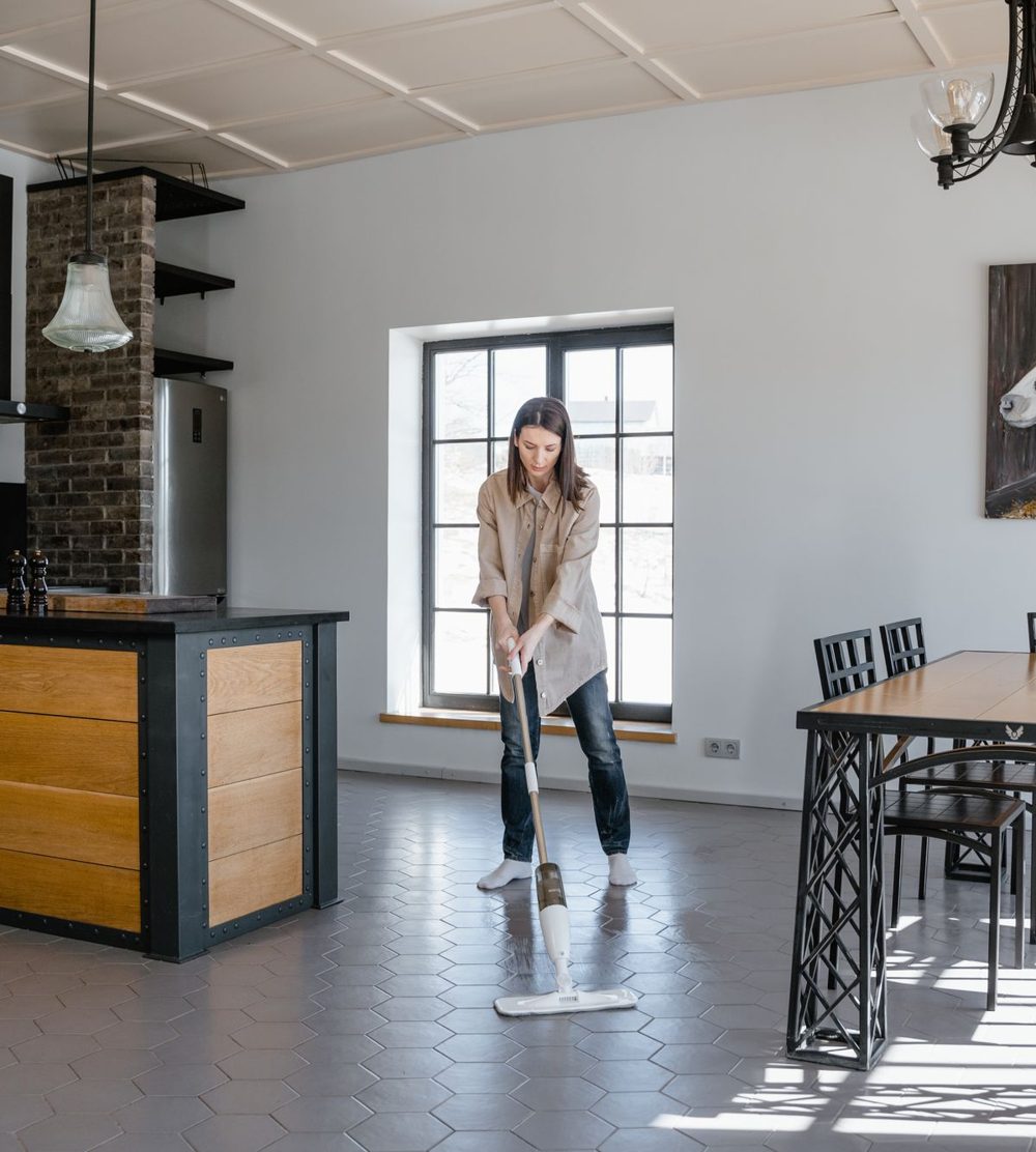 Cleaner mopping a dining room floor