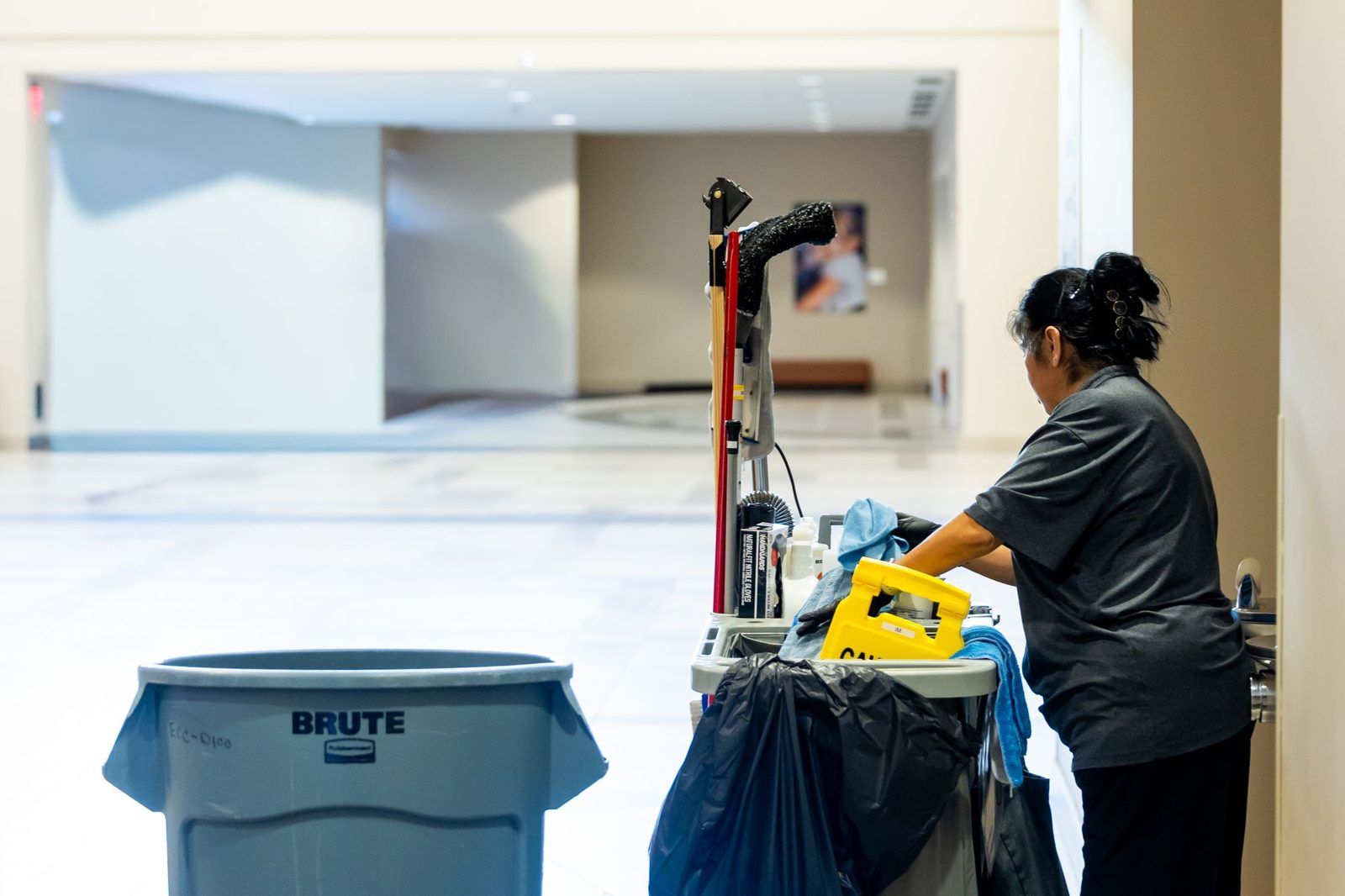 Commercial cleaner with a cleaning cart in an office building