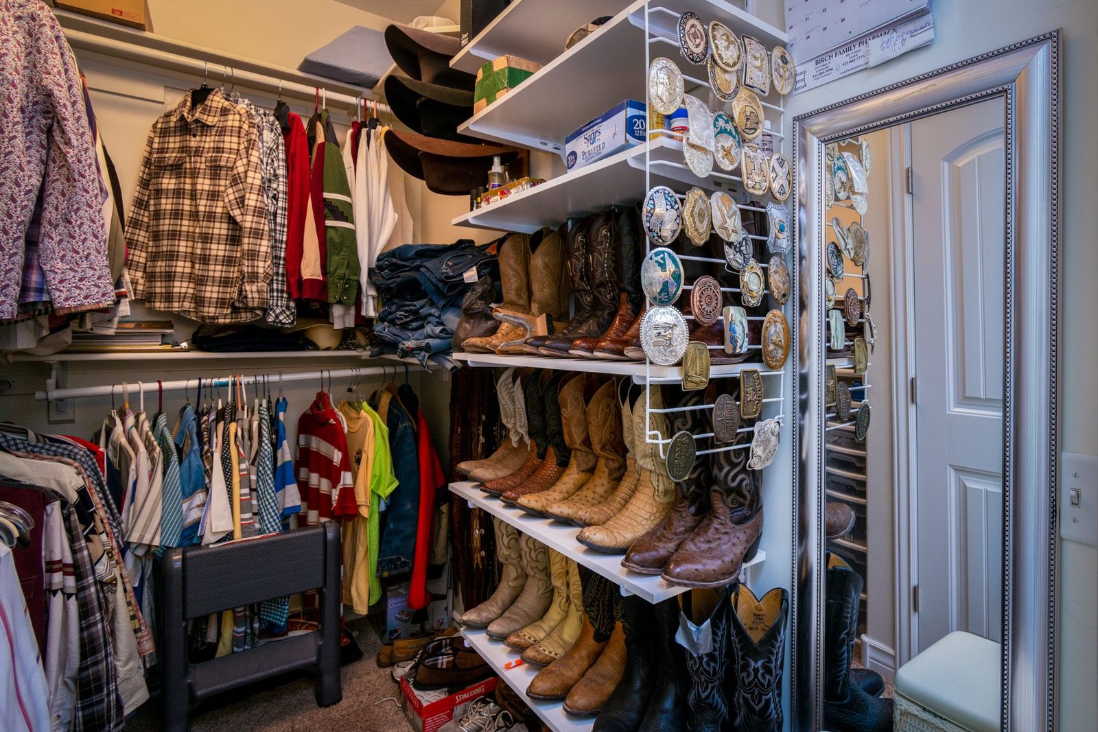 Neatly organized walk-in closet with shelves and hanging clothes
