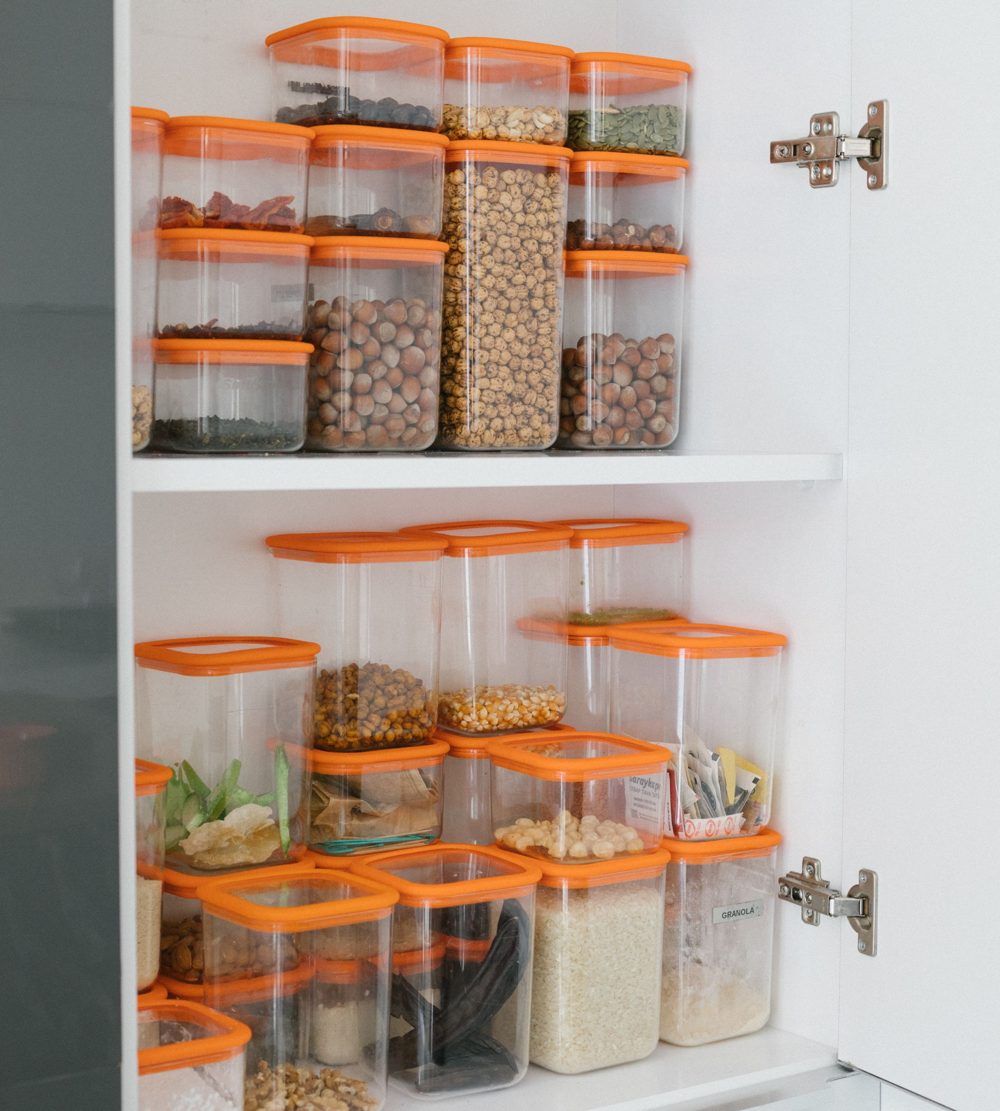 Pantry cabinet organized with clear storage containers