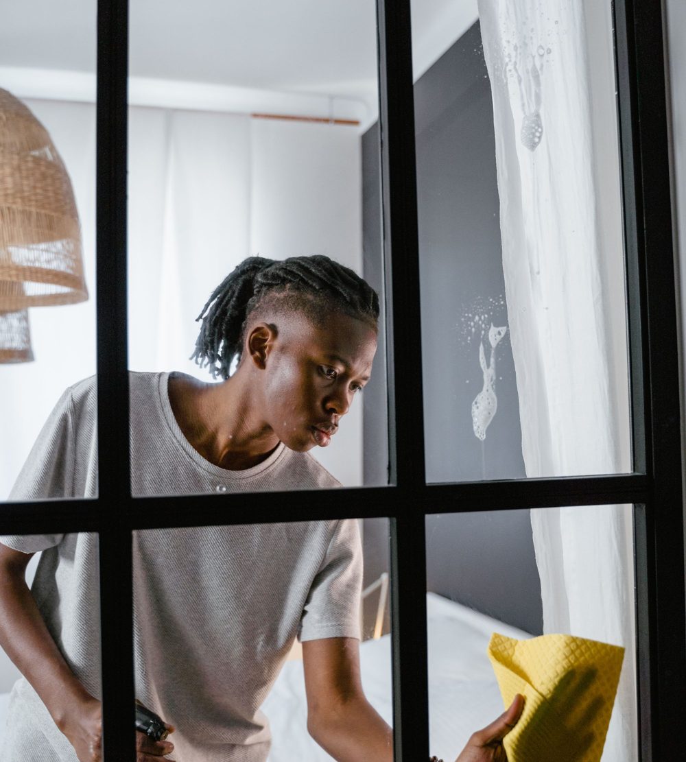 Cleaner wiping down a glass door